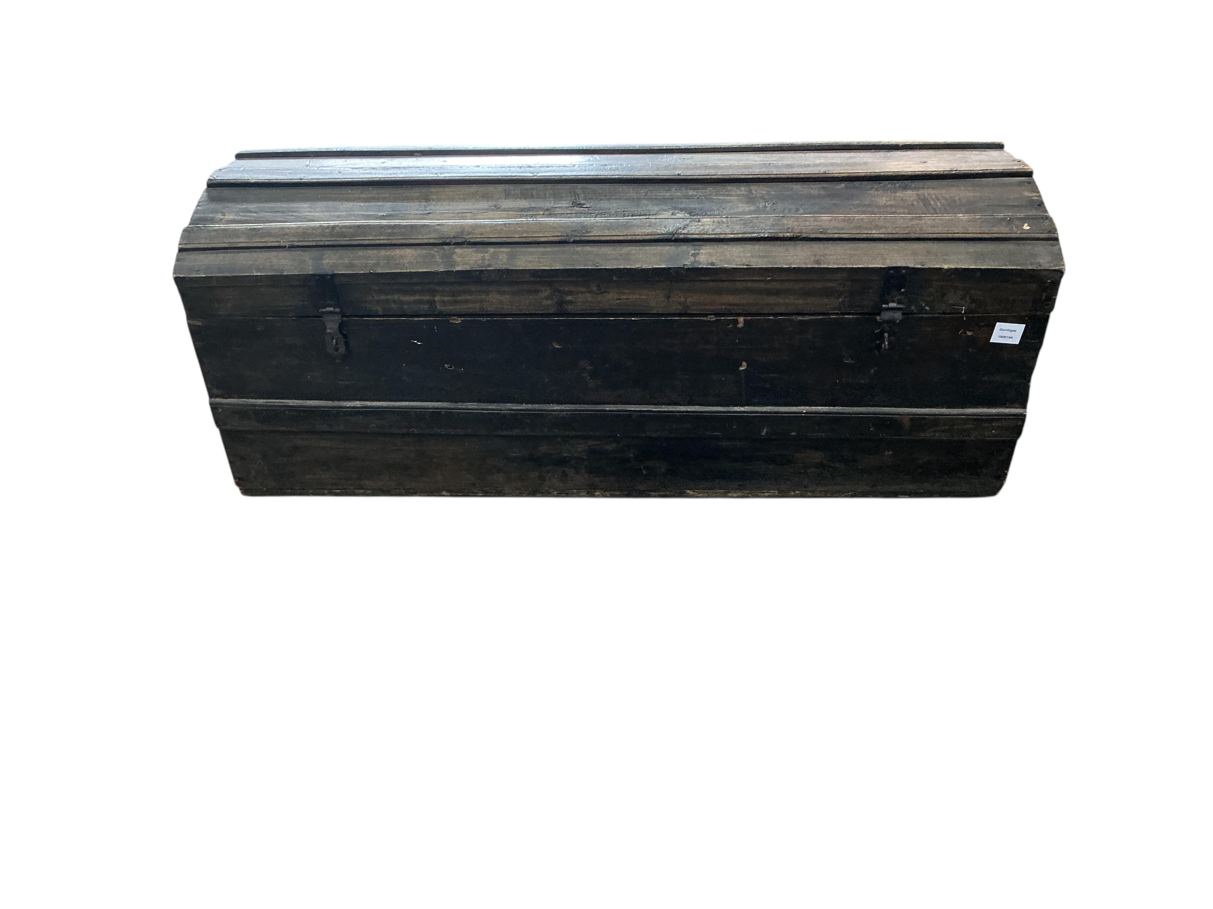 A stained pine domed top trunk, width 123cm, depth 46cm, height 47cm